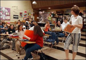 Cindy Harrison, right, directs her Emglish class at Bowsher High  School in the making of a time capsule.