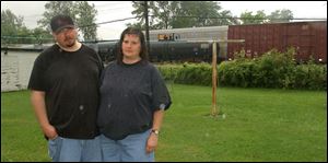 Dan and Judy Brown say railcars headed for a local landfill are supposed to haul construction debris but smell like trash. 