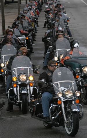 Hundreds of Harley-Davidson owners ride down Monroe Street from the Toledo Museum of Art toward the Toledo Zoo. About 1,800 members of the Harley Owners Group held their 2004 state rally here Thursday and yesterday.
