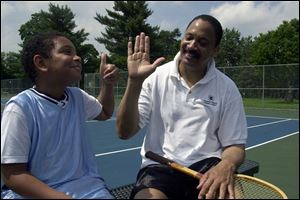 Johnny Mickler, 52, gets a thumbs-up from his 9-year-old son, Caleb, after sweating it out on the tennis courts.