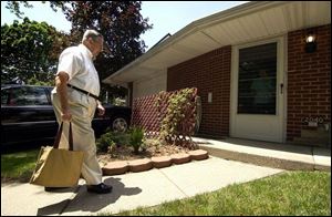 Robert Hastings, a salesman for Fuller Brush Co. for the last 40 years, makes a sales call at Louise Henderson's home in South Toledo.