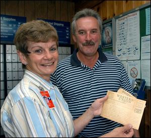 Margaret Welty holds the Western Union telegram that was sent to Private Duffey's family telling them their son was missing in action. Gene Carr, Mr. Duffey's nephew, looks on.