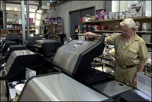 Among many shoppers this summer is Bob Faylor, of Swanton Township, inspecting a stainless-steel grill while browsing in the outdoor section of The Andersons in Maumee.