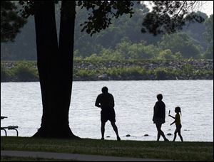 REG Rov  July 5, 2004-- Dave and Marie Durfey take a walk along the lakeshore with their granddaughter Jessica Durfey, 6. The three from Monclova were enjoying the weather Monday morning at Harrison Lake State Park near Fayette. Blade photo by Andy Morrison