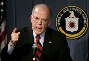 John McLaughlin, deputy director of the Central Intelligence Agency, responds to the Senate report, below right, bashing the agency. He said the agency is already making changes.
