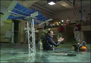 Reed Steele applauds the students' replica of the International Space Station.