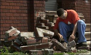 ROV BRICK BY BRICK 7/28/04 PHOTO BY LORI KING Terrance Highsmith Jr., 15, earns a little extra spending money as he helps renovate a brick front porch on Avondale.