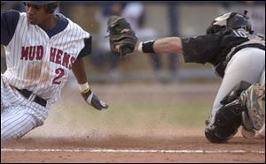 Nook Logan eludes the tag of Indianapolis catcher Mark Johnson in the third inning to score the Mud Hens' first run.