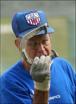 Norman Ameling, 85, of the Toledo Area Horseshoe Club takes aim in Toledo's Jermain Park. Mr. Ameling of Oregon had 26 ringers out of 50 throws.