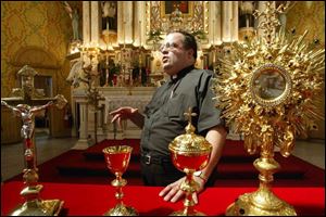 Father Mark Borkowski describes the liturgical vessels in St. Josaphat Catholic Church. associated press The Missal, with its text in Latin, rests on the altar.