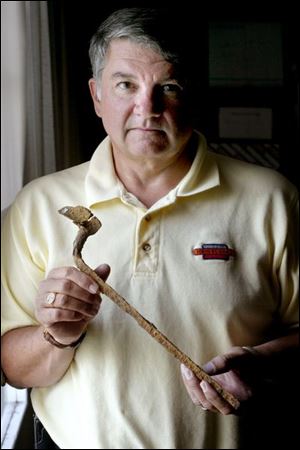 Dr. G. Michael Pratt holds a boyonet found in a 1995 survey of the Fallen Timbers battlefield. The survey helped to locate the site of the fight between the U.S. Army and area tribes.