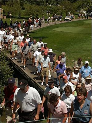 Golf fans flock to the first hole during the third round of the Jamie Farr Owens Corning Classic at Highland Meadows Golf Club in Sylvania. Thousands who turned out watched as Karen Stupples, winner of last week's Women's British Open, took the lead going into today's final round of the local tournament.