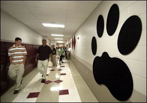 Visitors admire a likeness of a panther print in a hallway after yesterday's dedication ceremony for the $21 million school complex in Paulding, where 1,450 students attend classes.