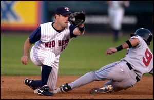 Indianapolis baserunner Ryan Knox slides safely under the tag of Hens second baseman Warren Morris during the fourth inning.