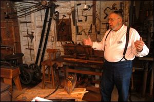 R sauder 1 .jpg Bill Collins of Montpelier gives a tour of Erie Sauders original workshop in Sauder village.  blade photo by herral long  8/17/2004