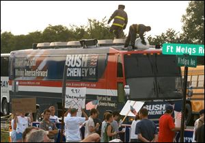 A Toledo firefighter washes off the Bush campaign bus after it was hit by an egg during the President's Perrysburg appearance. 