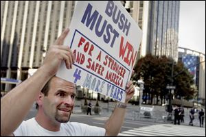 Jon Alvarez of New York stands across from Madison Square Garden in support of President Bush as more than 100,000 protesters approach from the south.
