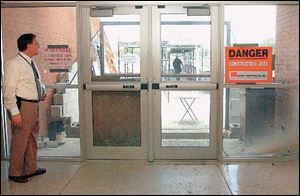 Maumee High School principal Larry Caffro takes opening day time to check construction of the performing arts center.