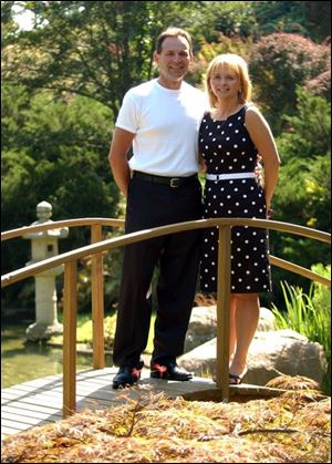 Jerry and Lori Herman of Rossford pause during the Hidden Gardens party at Schedel Arboretum and Gardens on Sunday.