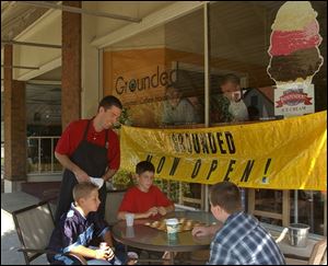 Grounded Gourmet Coffee House owner Chris Umbaugh checks on customers, from left: Nick Timmons, Cody Adler, and Nick Jankowski.