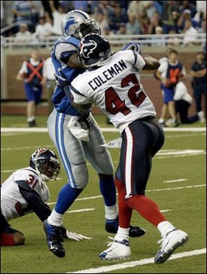 Lions wide receiver Roy Williams catches pass, then fights past Houston's Marcus Coleman to score his first NFL touchdown.