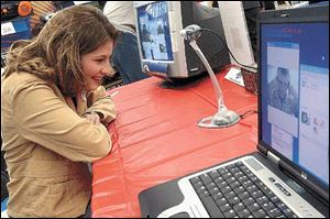 Tori Muehlfeld talks with her husband, Dustin, who is stationed in Iraq, at Toys 'R' Us in West Toledo.