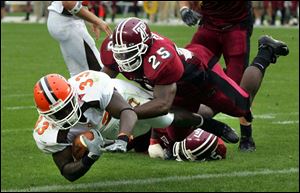 Bowling Green's P.J. Pope dives past Temple's Ryan Gore for one of his four touchdowns. Pope rushed for 106 yards on eight carries.
