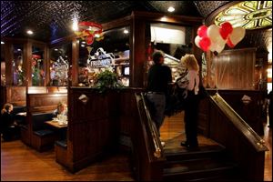 Patrons enter the smoking room at TGI Friday's on Airport Highway, where the popularity of the smoking lounge has caused employees to seek job assignments in that area.