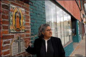 Maria L. Rodriguez-Winter shows off the painting of the Virgin of Guadalupe and the Ten Commandments on Broadway.