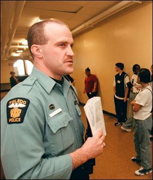 Toledo police Officer Russell Burke, assigned to Leverette Junior High, is one of 12 officers leaving their school posts Jan. 1.