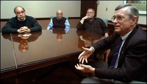 Swift Boat Veterans for Truth members Mike Solhaug, Dick Pees, and Steve Gardner and ex-POW Ken Cordier, right, discuss John Kerry's record in Vietnam at a talk in the Radisson Hotel.
