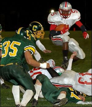 Central Catholic's Nikai Roberts leaps over a pile deep in Clay territory.