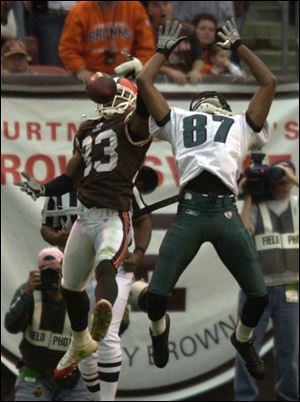 Cleveland's Daylon McCutcheon, left, breaks up a pass thrown to Philadelphia's Todd Pinkston in overtime.