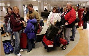 Rachael Jablonski, 15, left, and Taylor Parks, 14, wait to board a train with Taylor's stepsister, Jessica Genaro, 9, and her dad, Tony Genaro, and grandparents Ellie and Russell Patton.
