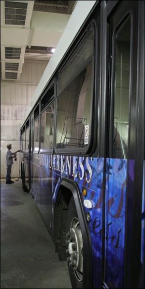 A bus wrap is installed in the TARTA garage.
