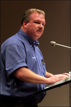 Toledo resident Ed Nagle speaks against a proposed trash fee during a meeting.
