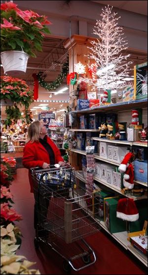 Pre-lighted trees such as one catching the eye of Vicki Lombar are popular.
