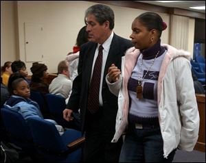 Melinda Ragland is escorted out of the courtroom by security after her arraignment in Lucas County Common Pleas Court. Ms. Ragland was charged after a fire on Oct. 24 killed seven children in her apartment.
