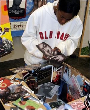 Toledo School for the Arts sophomore Maya Williams applies some finishing touches to her mixed media creation for the Community He(art)beats Exhibition.