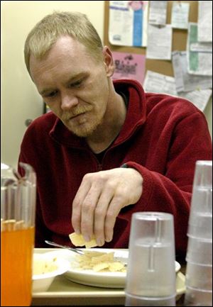 Bob Mazey eats his dinner at the City Mission in Findlay.