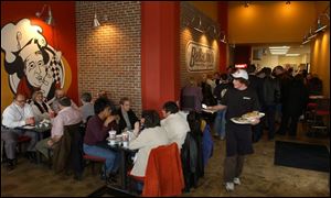 Lunch-time customers crowd Bellacino's Pizza and Grinders, at Huron and Adams streets.