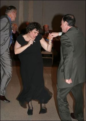 SWINGING INTO 2005: Sydney Schreibman and her fiance, Jim Ross, swing in the new year with Johnny Knorr at Stranahan Great Hall.