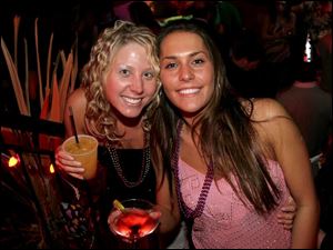 YEAR ENDS, YEAR STARTS: Tiffany Arlaro, left, and Stephanie Minnich toast a year of friendship past and future at Gumbo's.