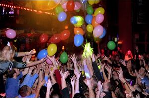 IN WITH NEW: Revelers try to catch balloons as 2005 dawns at Gumbo's Bayou Grille.