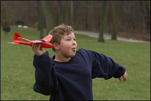ROV FLYING HIGH 12/31/04 PHOTO BY LORI KING Since sledding is no longer an option due to mild temps, Holland, OH resident Anthony Frohlich, 9, instead flies his air hog airplane he recieved for Christmas during a family outing at Wildwood Metropark.