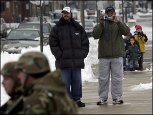 Curious and surprised spectators watch the Marine exercises downtown. James Eggleston of Elyria used his video camera to capture the military training for later viewing.
