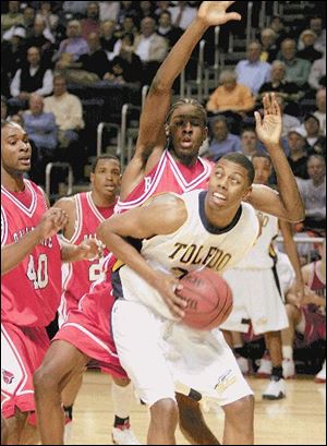 Ball State's Terrance Chapman tries to defend Toledo's Anton Currie from behind last night in Savage Hall. Toledo evened its MAC record with a victory as the Rockets placed four players in double figures.