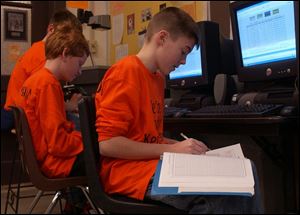 At Otsego Middle School, Tyler Carson fills out the required charts tracking his team s choices.