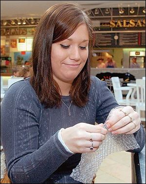 University of Toledo student Rachel Maiberger begins by popping the bubbles along the edge.