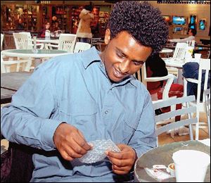 UT student Abe Hussein pops slowly, savoring a sheet of Bubble Wrap for a couple of days.